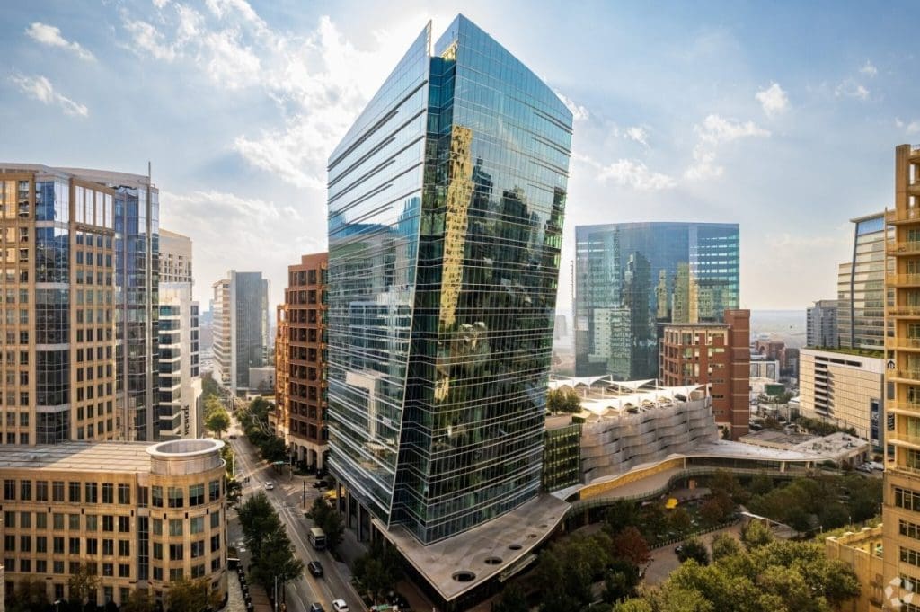 The McKinney & Olive Tower standing prominently in Uptown Dallas, displaying a sleek glass envelope and angular lines structurally engineered by Childress Engineering