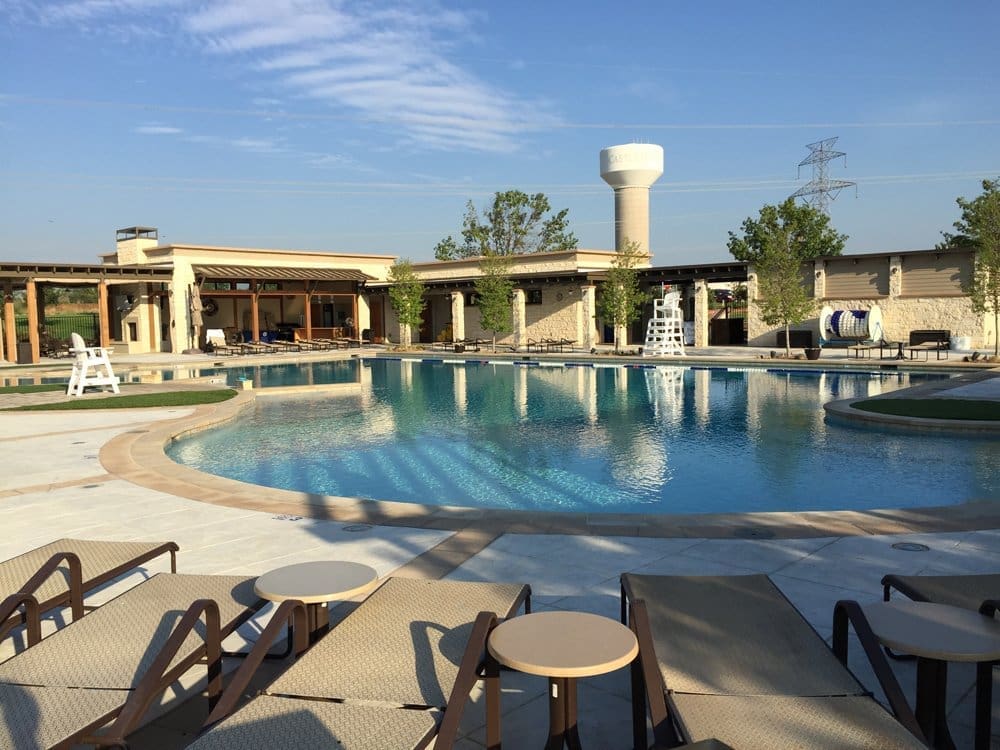 Lexington Amenity Center swimming pool area with nearby buildings featuring CES residential architectural design and structural engineering under a clear blue sky
