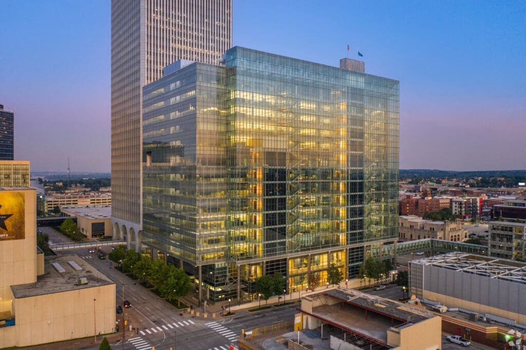 Dusk view of the Wiltel Communications Tower, highlighting the illuminated glass curtainwall system that was successfully remediated under the guidance of Childress Engineering