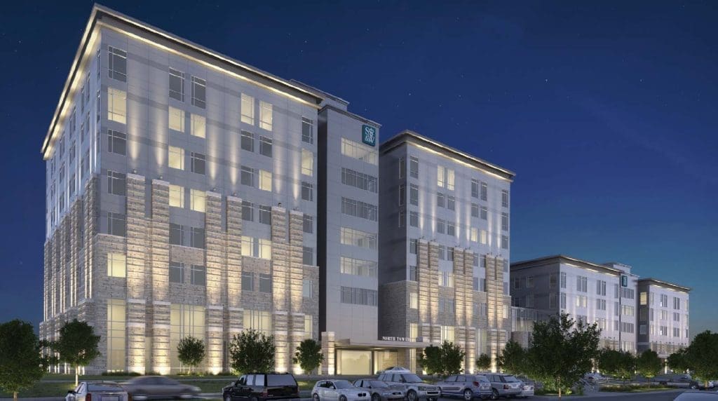 Angled perspective of the hospital exterior, highlighting the glass curtainwall system re-engineered by Childress Engineering to ensure water-tight performance