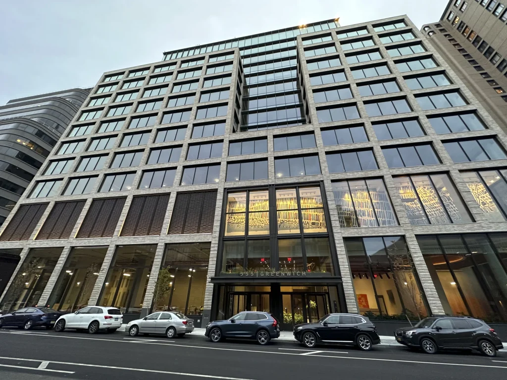 A modern multi-story office building with large glass windows, offering expert consulting in structural engineering, and several parked cars in front, seen from street level at 125 Greenwich Street.