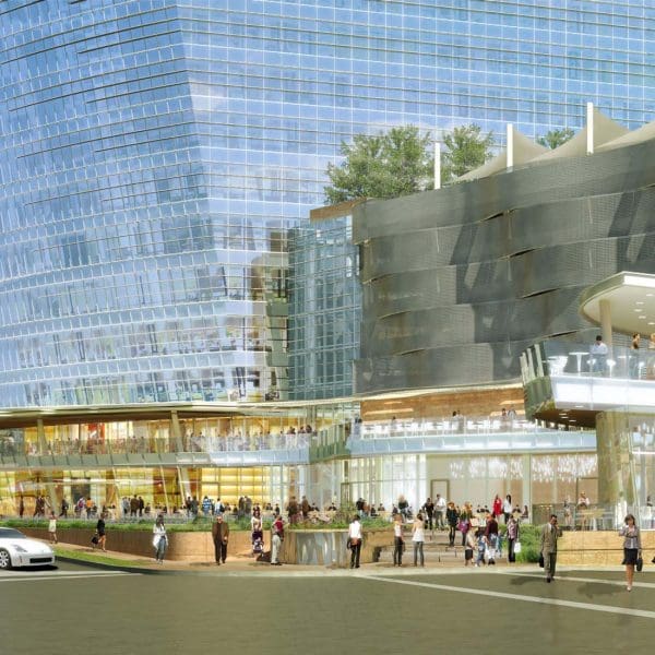 Exterior view of the building's curved podium and outdoor plaza, featuring a custom glass curtainwall system that CES helped layout and engineer for precision fit