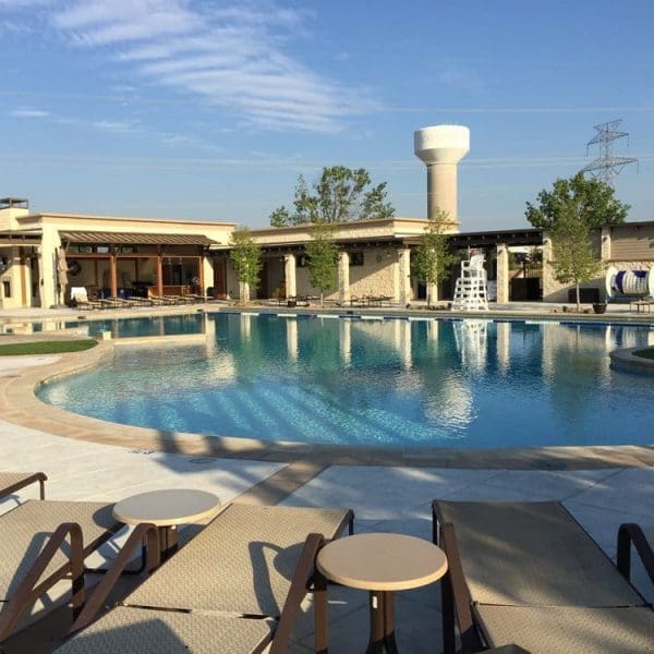 Lexington Amenity Center swimming pool area with nearby buildings featuring CES residential architectural design and structural engineering under a clear blue sky