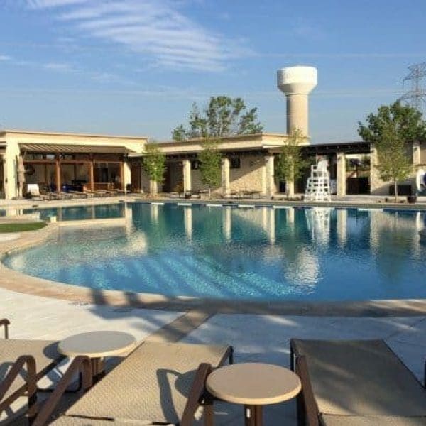 Lexington Amenity Center swimming pool area with nearby buildings featuring CES residential architectural design and structural engineering under a clear blue sky