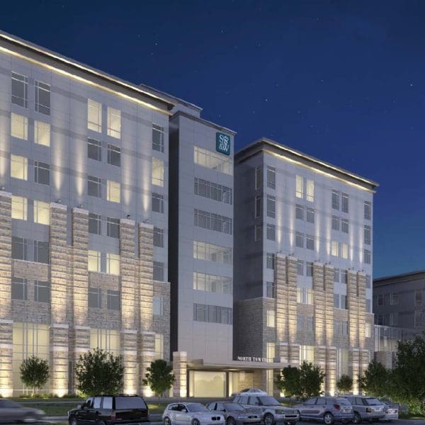 Angled perspective of the hospital exterior, highlighting the glass curtainwall system re-engineered by Childress Engineering to ensure water-tight performance