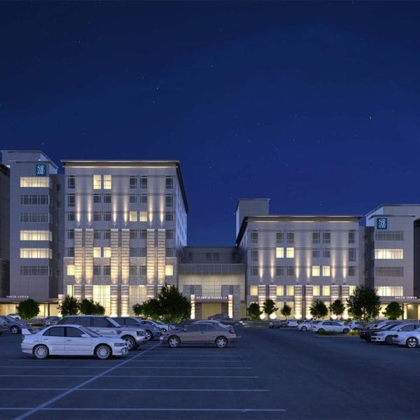 Night view of the Scott & White Hospital CAM Facility, featuring a modern illuminated entrance canopy and facade elements remediated by Childress Engineering