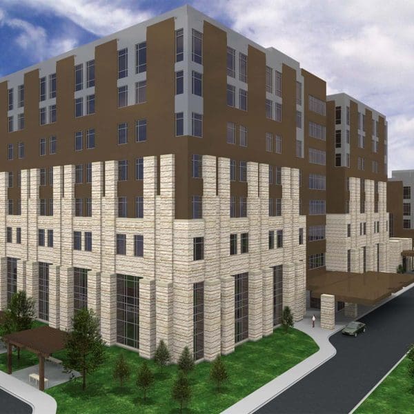 Daytime exterior of the multi-story hospital facility, showcasing the stone cladding and window wall systems assessed and repaired by Childress Engineering